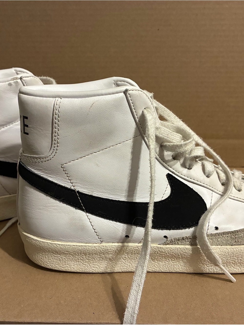 Nike White High-Top Sneakers with Black Swoosh